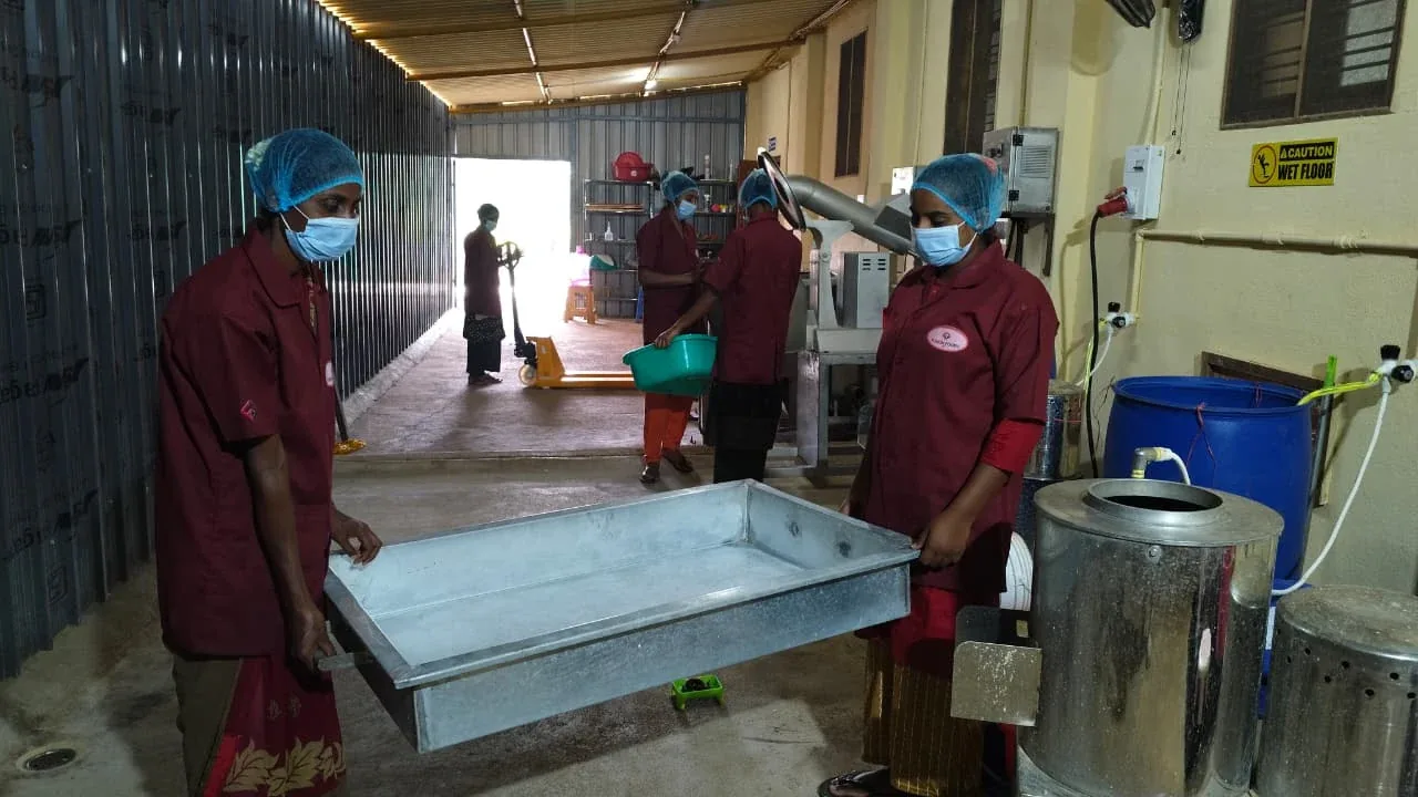Fusion Foods operators monitoring frying machinery